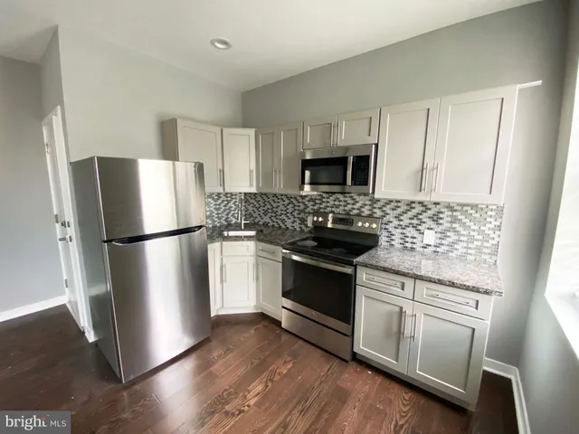 a kitchen with stainless steel appliances a refrigerator stove and sink
