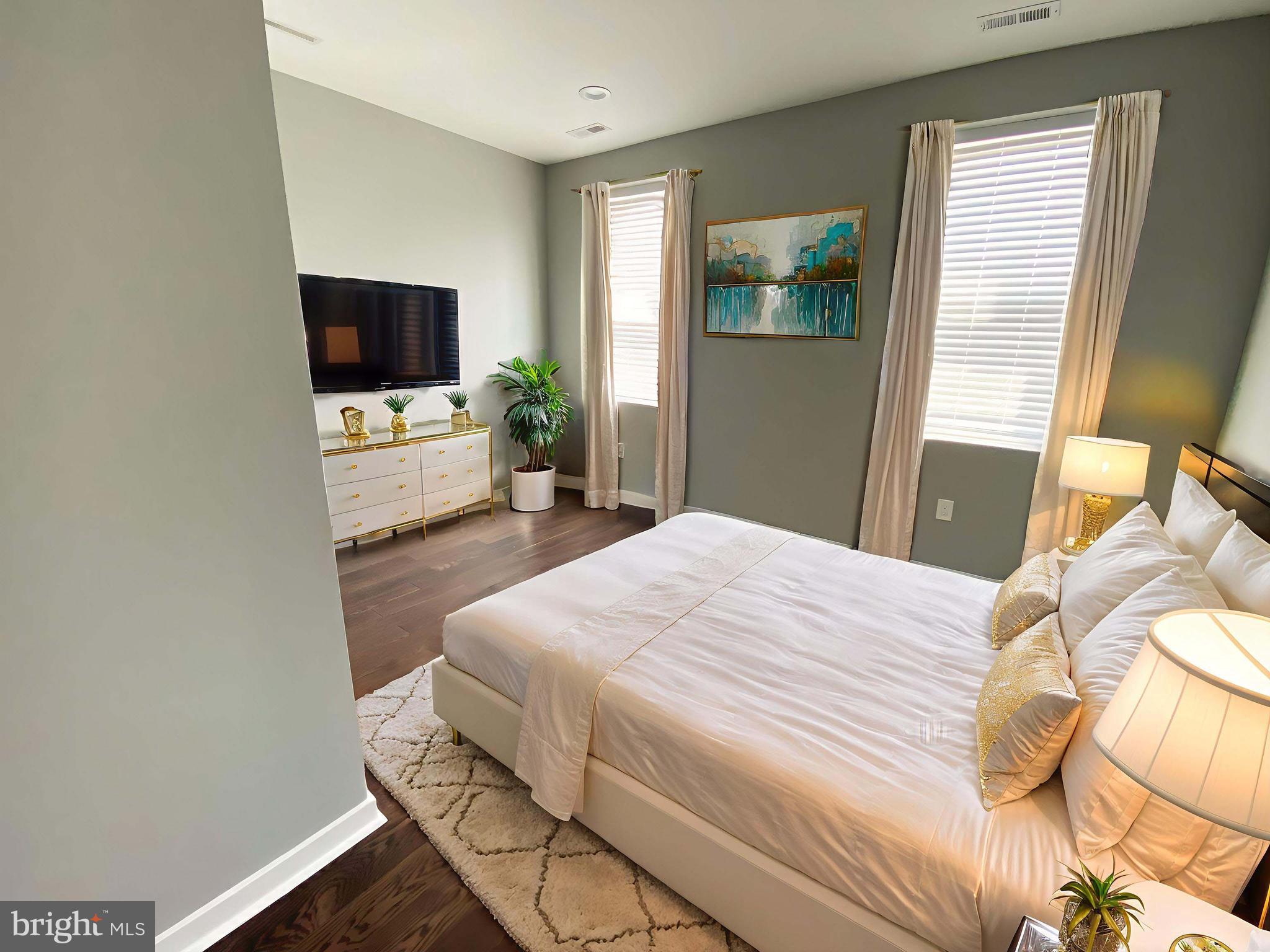 1801 West Venango Street, Unit 4 Philadelphia, PA 19140 - Photo 5 of 21 a bedroom with a bed and a flat screen tv