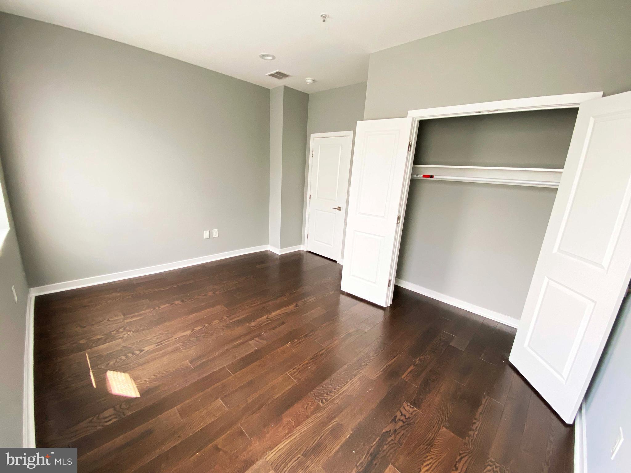 1801 West Venango Street, Unit 4 Philadelphia, PA 19140 - Photo 8 of 21 wooden floor in an empty room