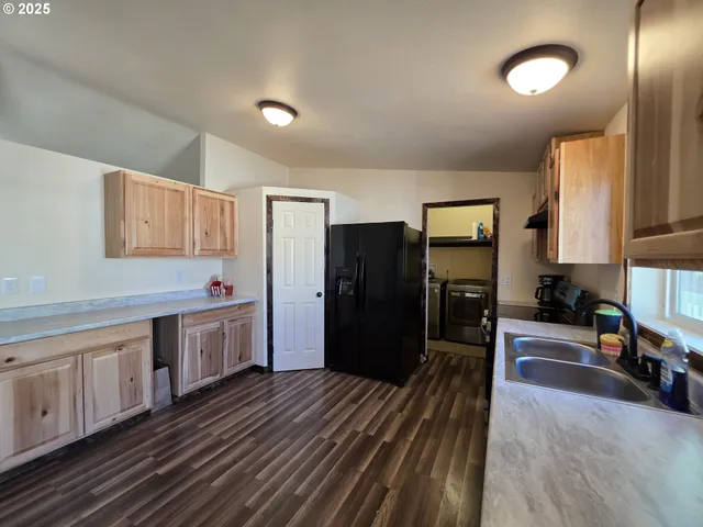 a kitchen with stainless steel appliances a refrigerator and a stove