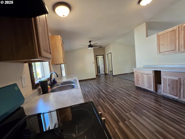 a view of a workspace with furniture and wooden floor