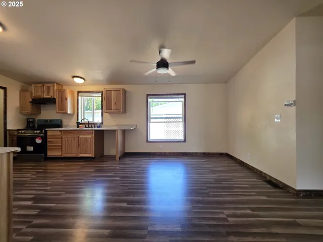 a view of a kitchen with sink and cabinets