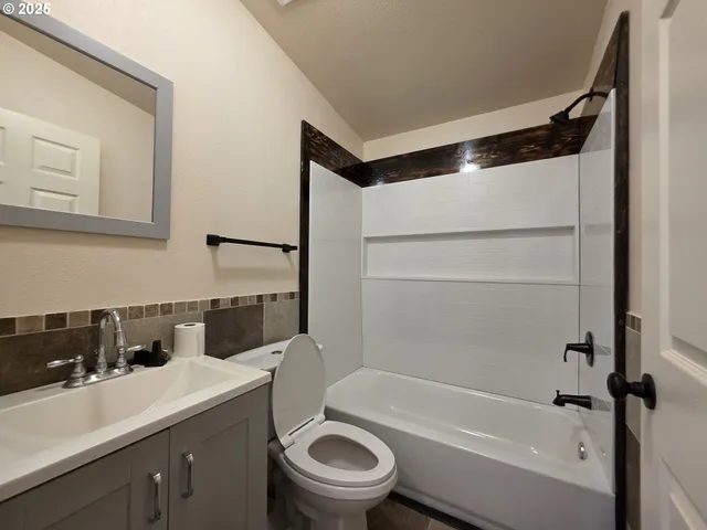 a bathroom with a sink a toilet and a bathtub