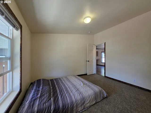 a bed sitting in a room next to a window