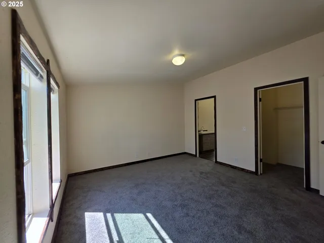 a view of a bathroom with a sink wooden floor and a mirror