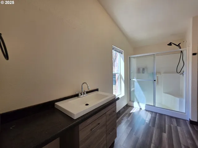 a bathroom with a glass shower door