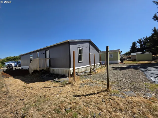 a view of a yard with wooden fence