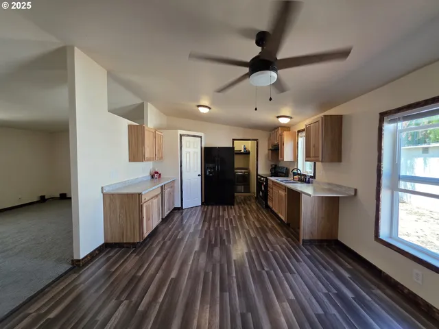 a kitchen with sink cabinets and wooden floor