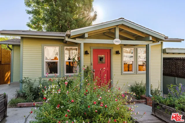 a front view of a house with plants