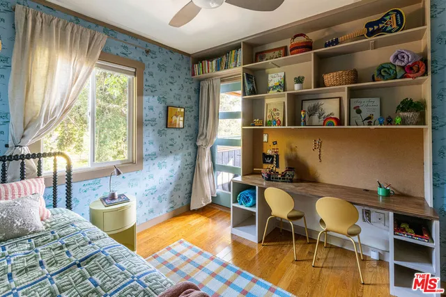 a bed sitting in a bedroom next to a window