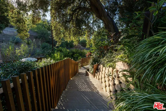 a view of a chair and tables in the back yard of the house