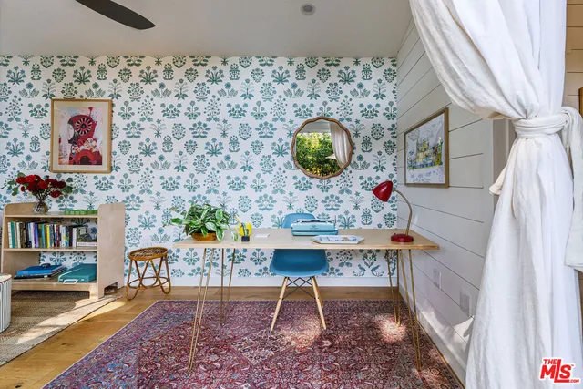 a living room with furniture and a painting on the wall