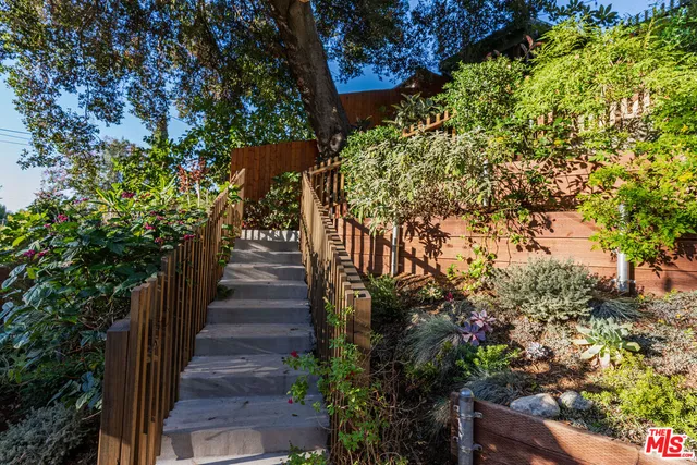 a wooden bench sitting in front of a building