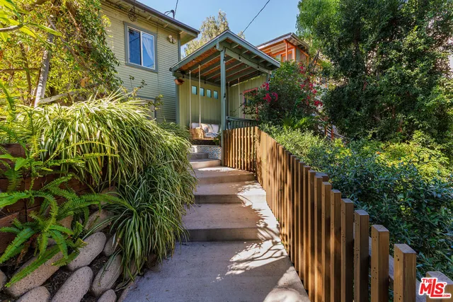 an aerial view of a house with a yard and potted plants