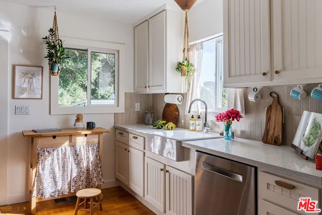 a kitchen with a sink cabinets and window