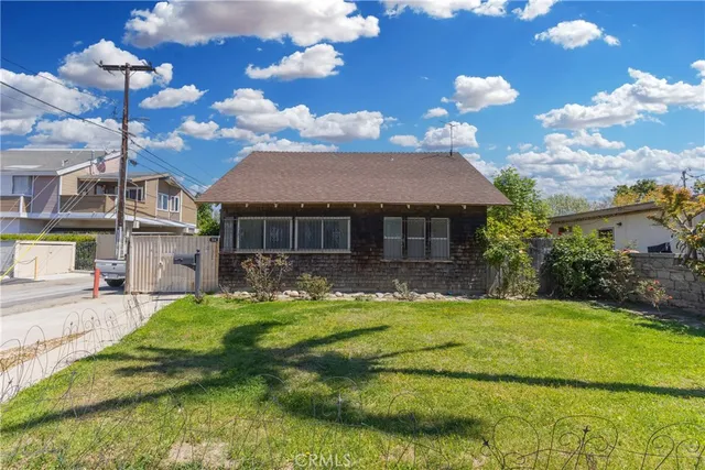 a view of a house with swimming pool and a yard