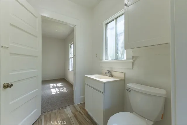 a bathroom with a toilet a sink and mirror