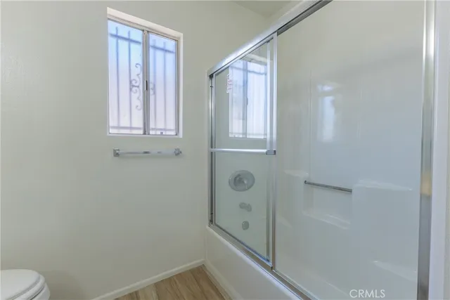 a bathroom with a shower and toilet
