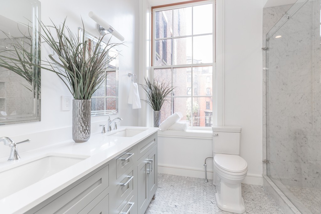 11 Exeter Street, Unit 3 Boston, MA 02116 - Photo 11 of 17 a bathroom with a granite countertop sink a toilet and a window