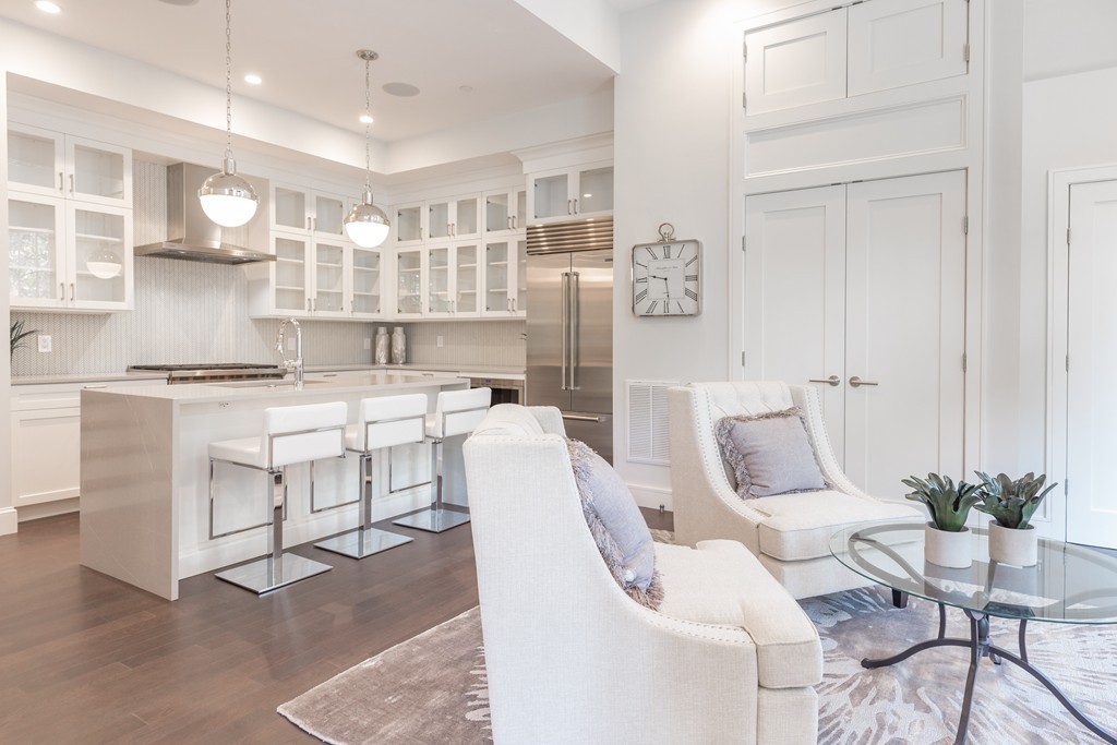 11 Exeter Street, Unit 3 Boston, MA 02116 - Photo 5 of 17 a living room with furniture a table and kitchen view