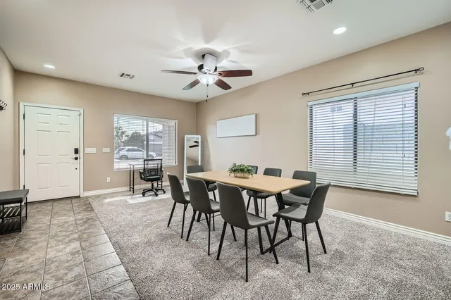 a view of a dining room with furniture and a chandelier