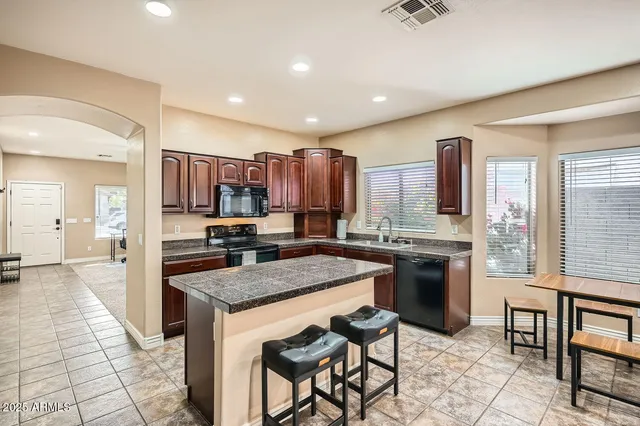 a kitchen with a stove a refrigerator and a sink