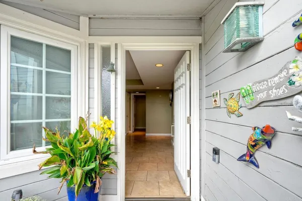 a view of a hallway with wooden floor and a potted plant