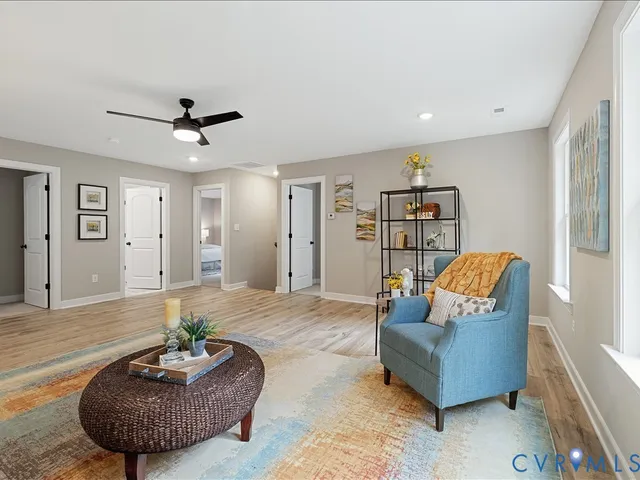 a living room with furniture and a wooden floor