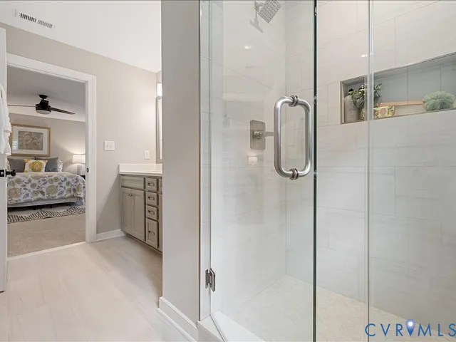 a bathroom with a glass shower door and a bath tub