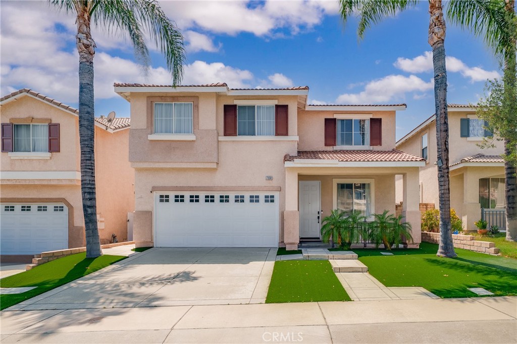7358 Freedom Rancho Cucamonga, CA 91730 - Photo 1 of 34 a front view of a house with a yard and a garage
