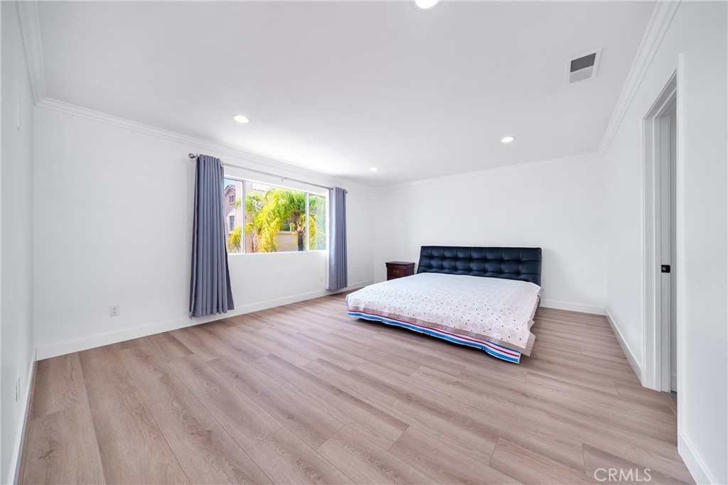 7358 Freedom Rancho Cucamonga, CA 91730 - Photo 19 of 34 a bedroom with a bed and wooden floor