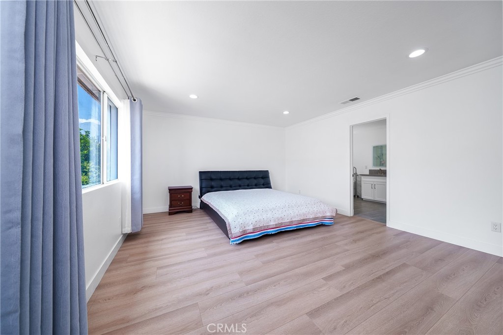7358 Freedom Rancho Cucamonga, CA 91730 - Photo 20 of 34 a spacious bedroom with a bed and a large window