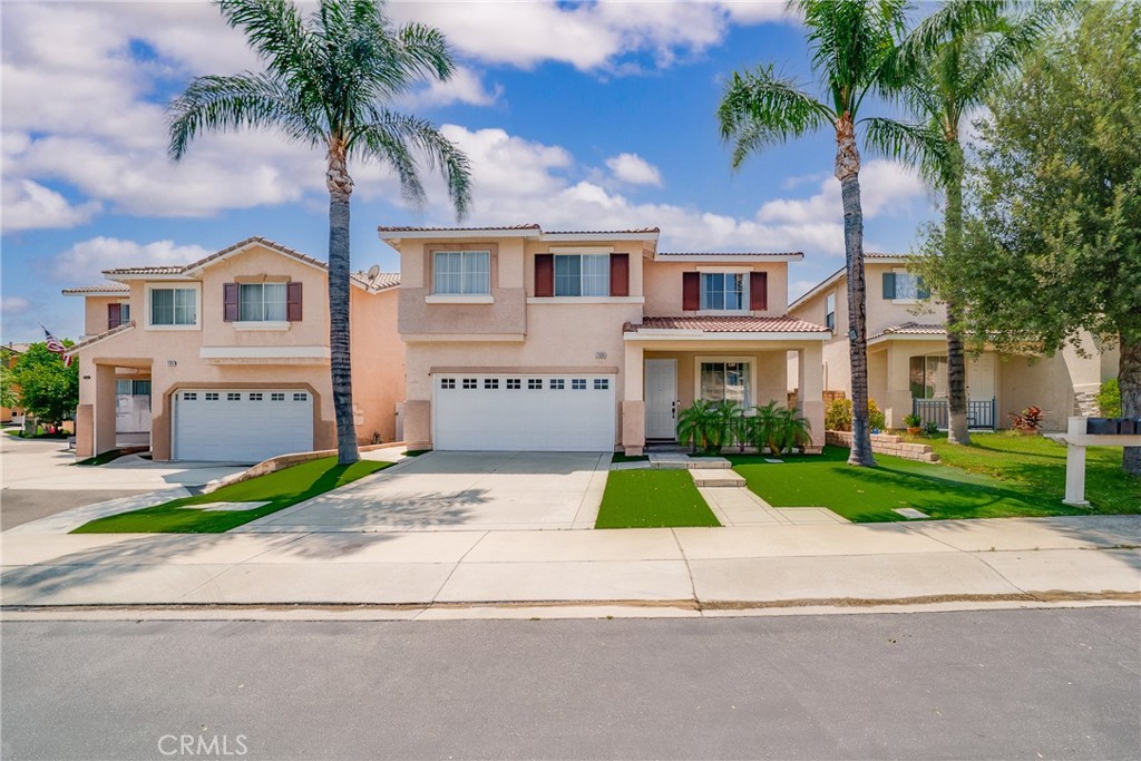 7358 Freedom Rancho Cucamonga, CA 91730 - Photo 2 of 34 a front view of a house with a yard and garage