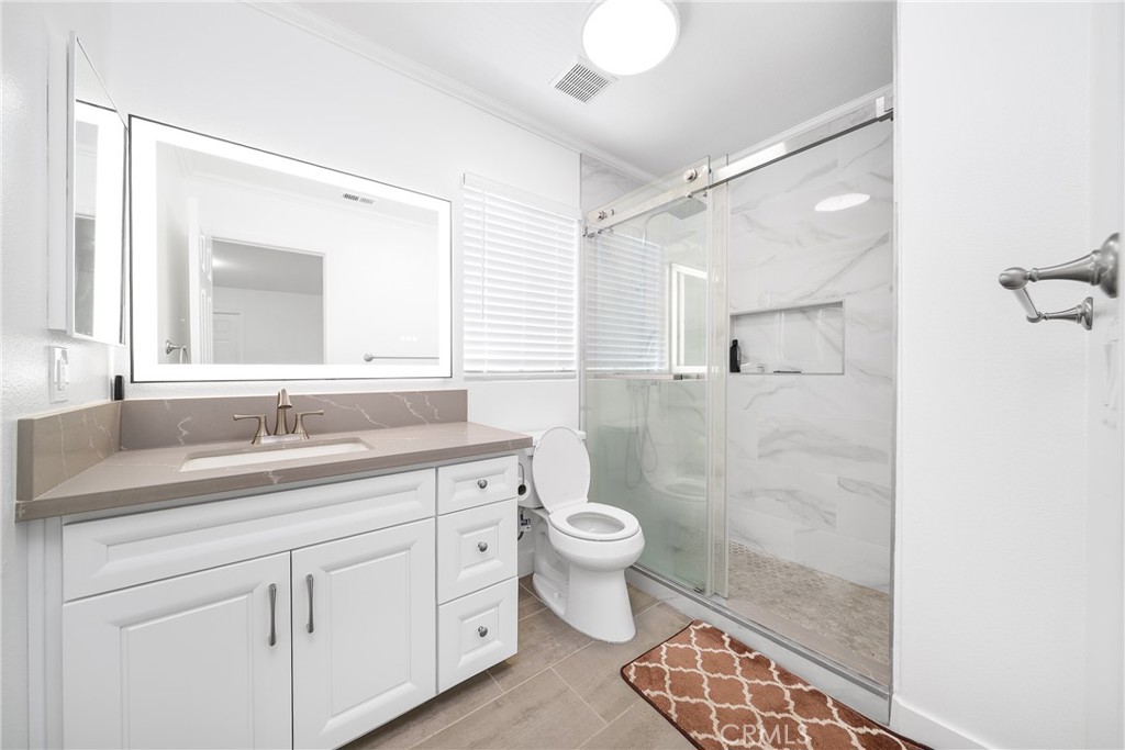 7358 Freedom Rancho Cucamonga, CA 91730 - Photo 25 of 34 a bathroom with a double vanity sink toilet and shower