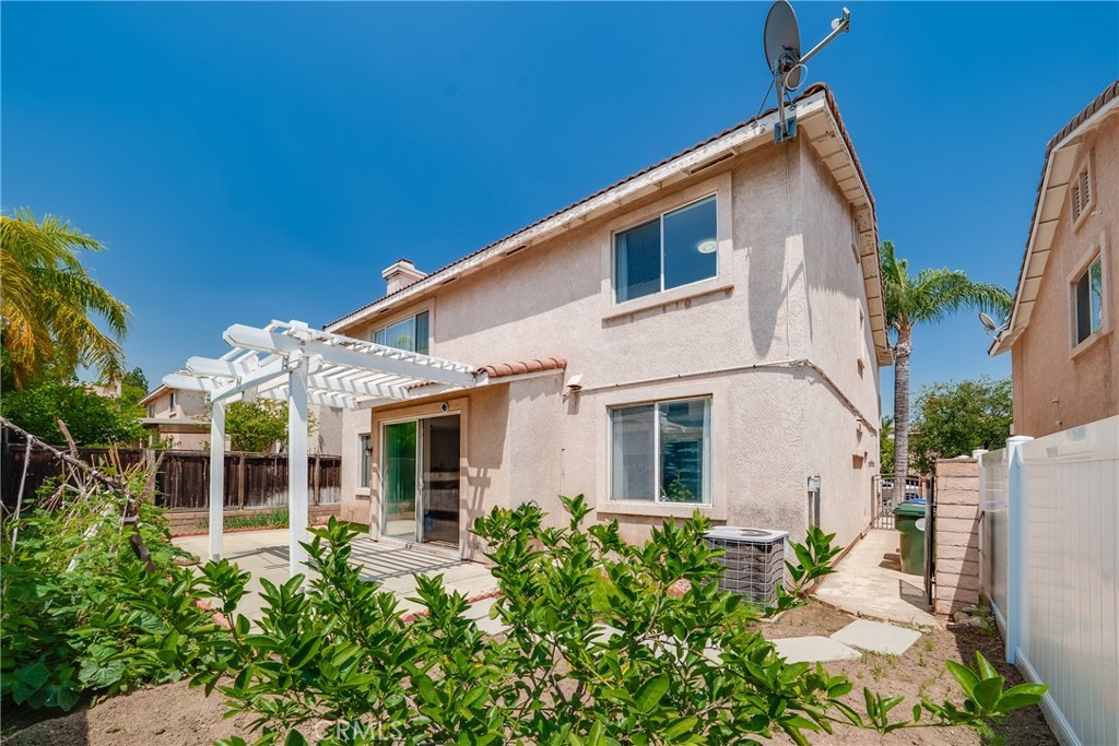 7358 Freedom Rancho Cucamonga, CA 91730 - Photo 26 of 34 a view of a white house with large windows and potted plants