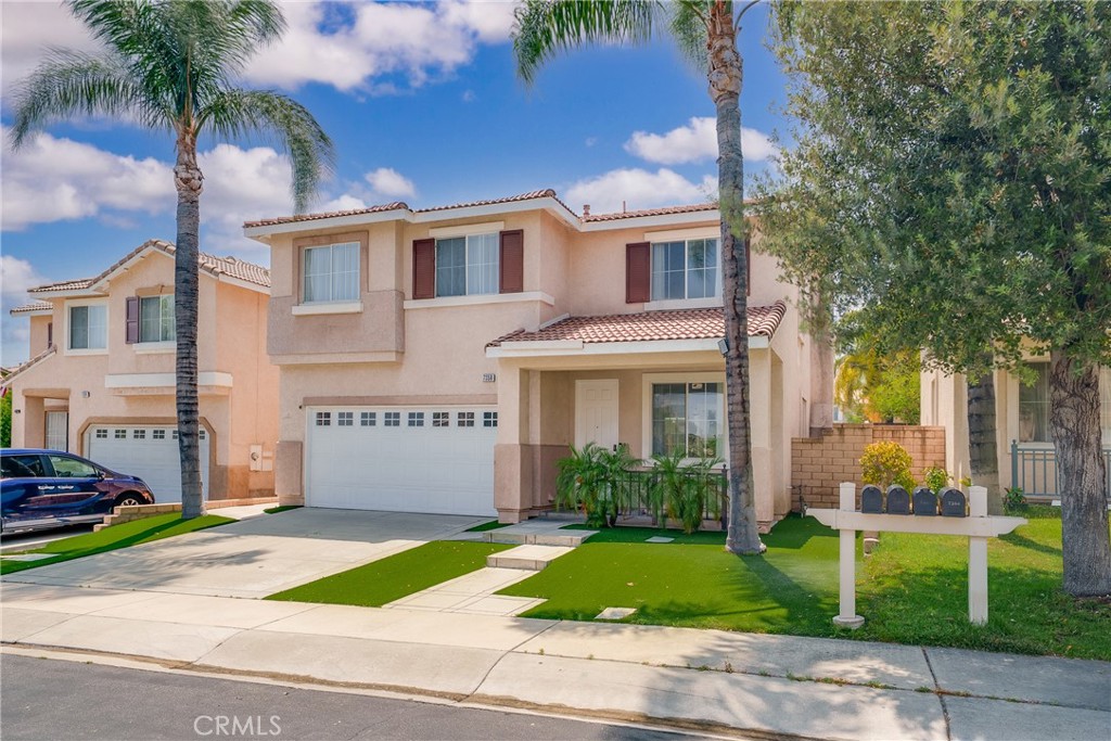 7358 Freedom Rancho Cucamonga, CA 91730 - Photo 4 of 34 a front view of a house with a garden and trees
