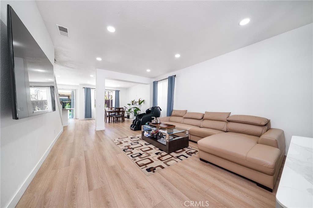 7358 Freedom Rancho Cucamonga, CA 91730 - Photo 9 of 34 a living room with furniture wooden floor and a large window