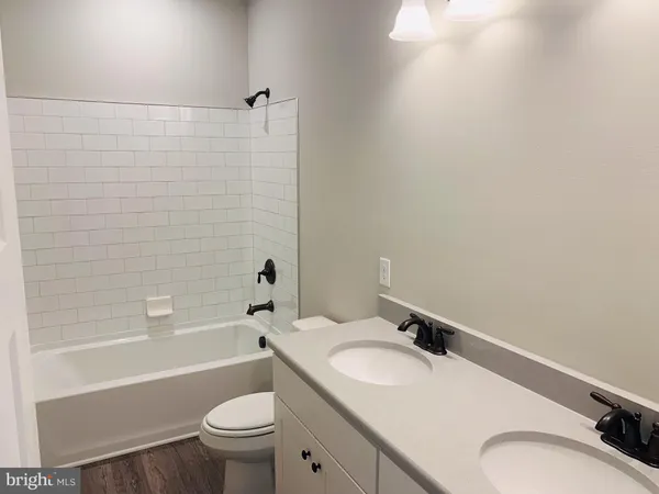 a bathroom with a sink a toilet and a bathtub