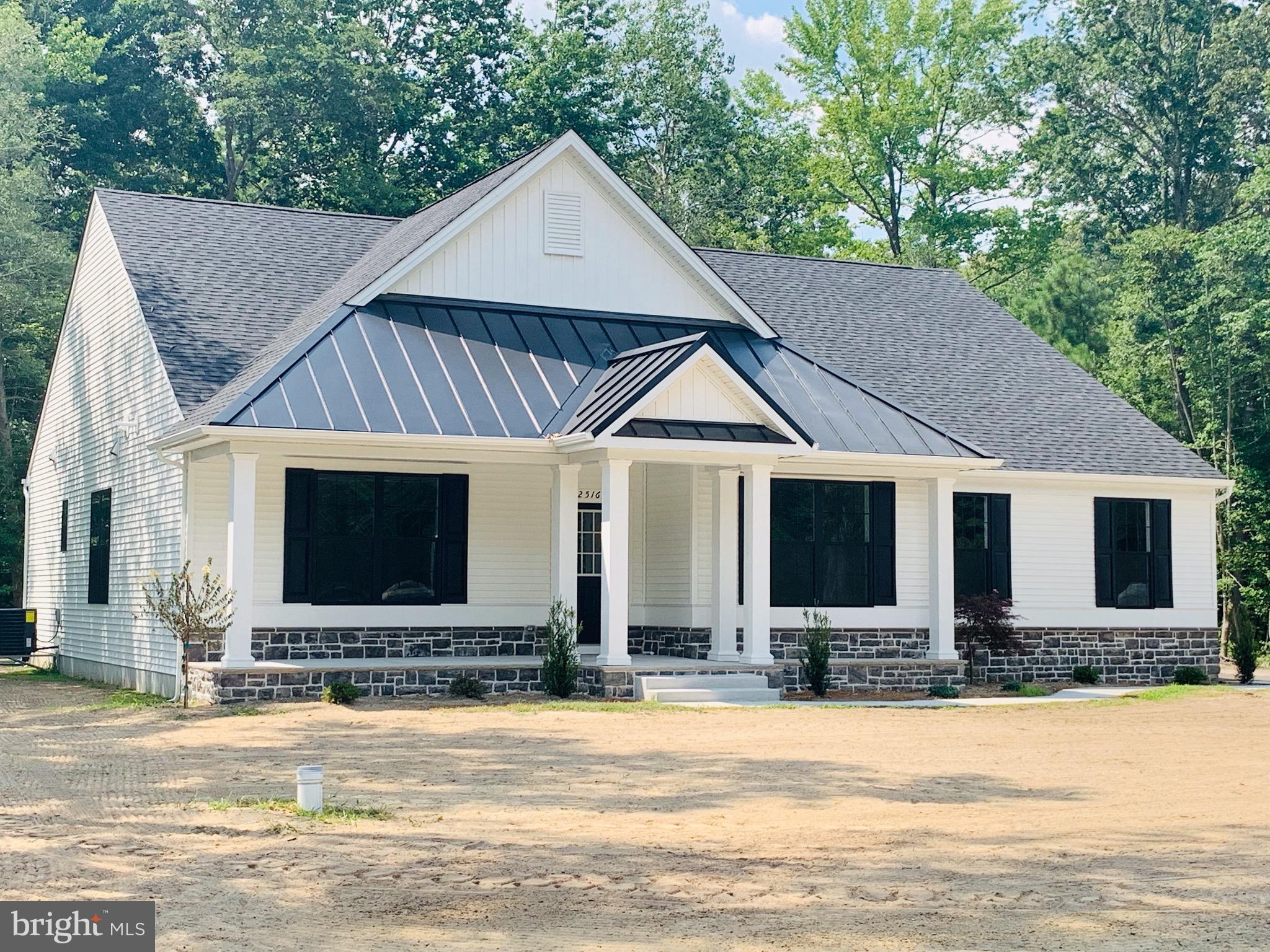 10 Henry's Way Georgetown, DE 19947 - Photo 4 of 47 a front view of house with yard and trees in the background