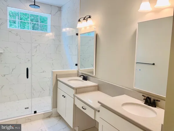 a bathroom with a sink double vanity and a shower