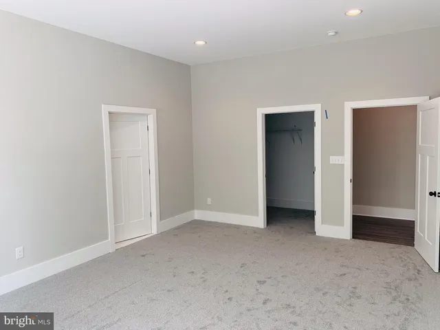 an empty room with closet area