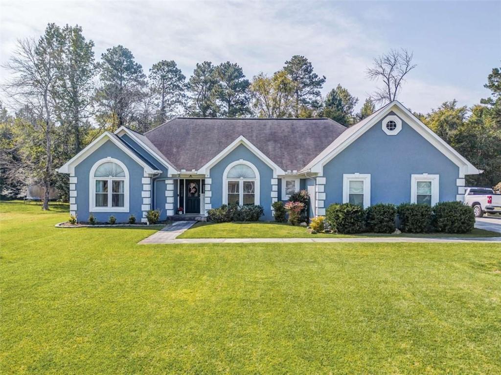 a front view of house with yard and green space