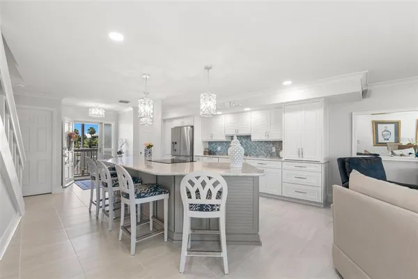 a large kitchen with a table and chairs