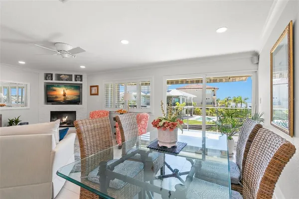 a living room with furniture a flat screen tv and a large window