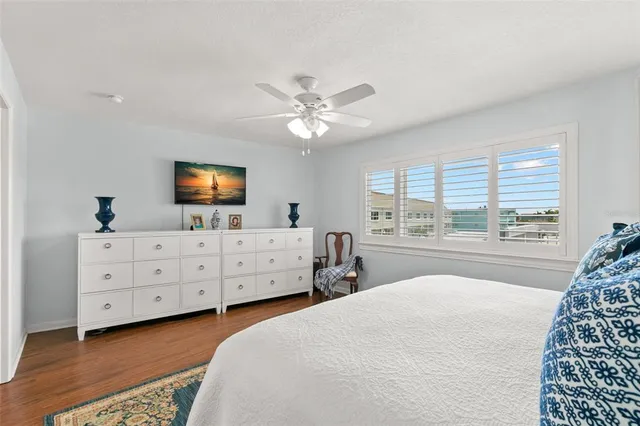 a bedroom with a large bed and a dresser