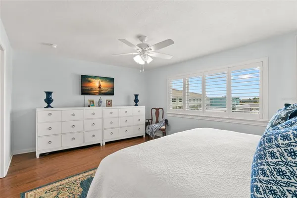 a bedroom with a large bed and a dresser