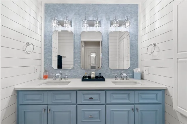 a bathroom with a double vanity sink and a mirror