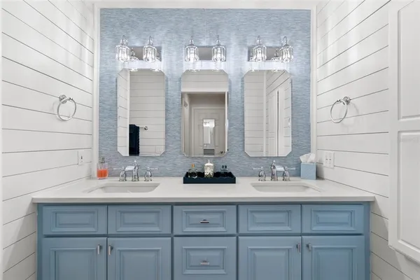 a bathroom with a double vanity sink and a mirror