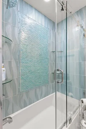 a bathroom with a shower and a sink