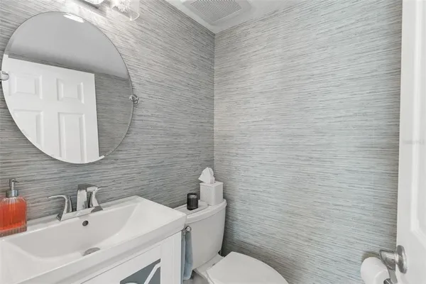 a bathroom with a sink mirror and toilet